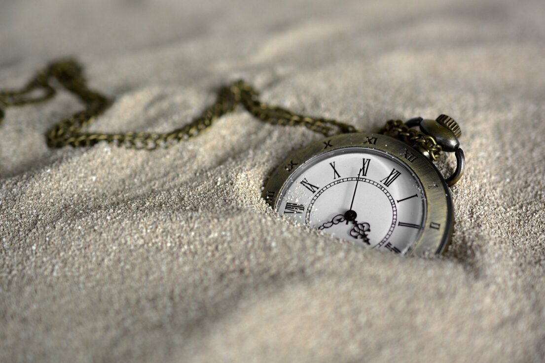 A pocket watch in the sand