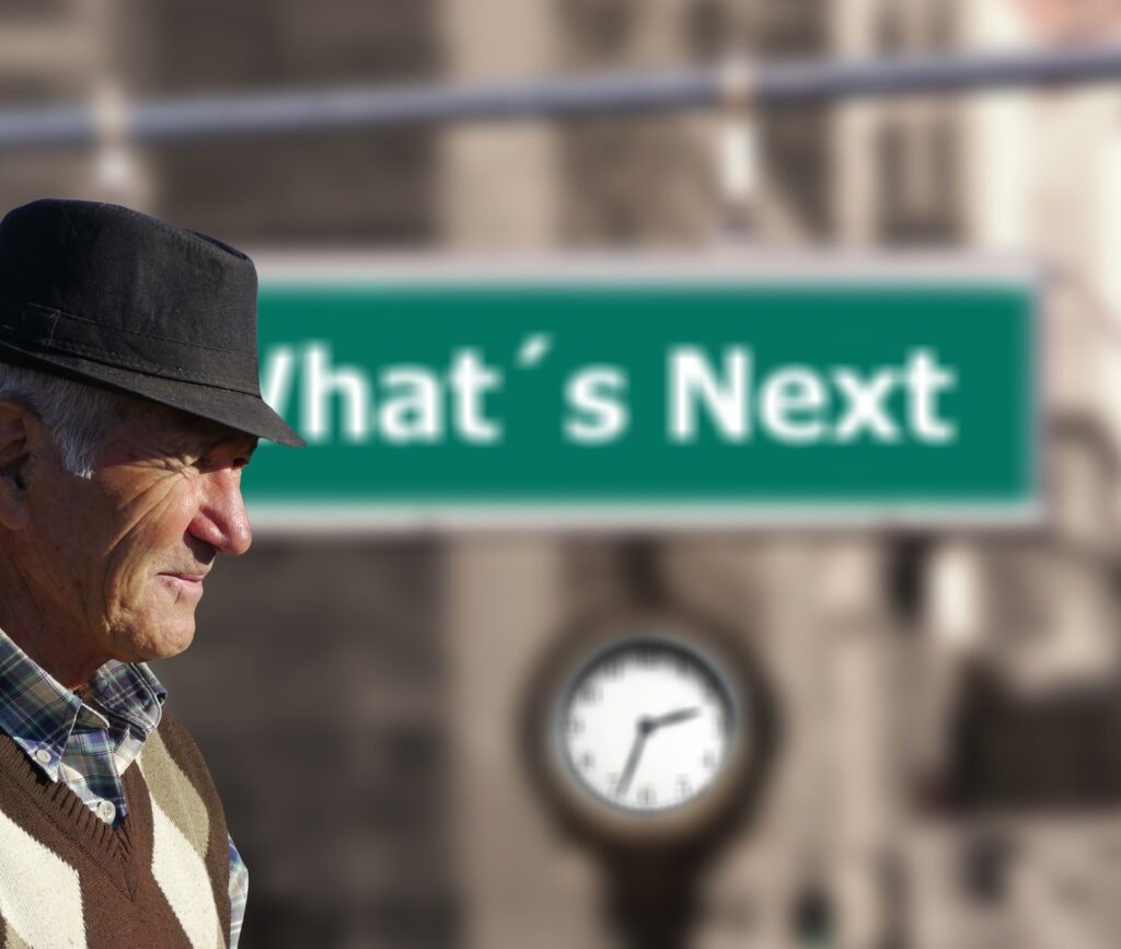 A Senior in Front of a sign that reads 'What's Next'