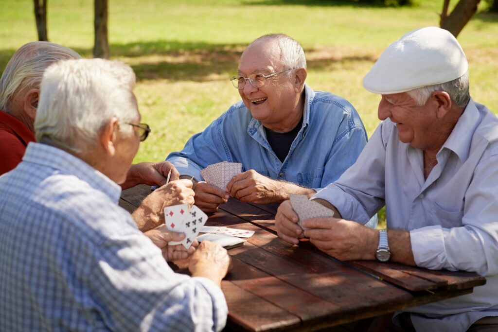 Seniors Happily Playing Cards Outside