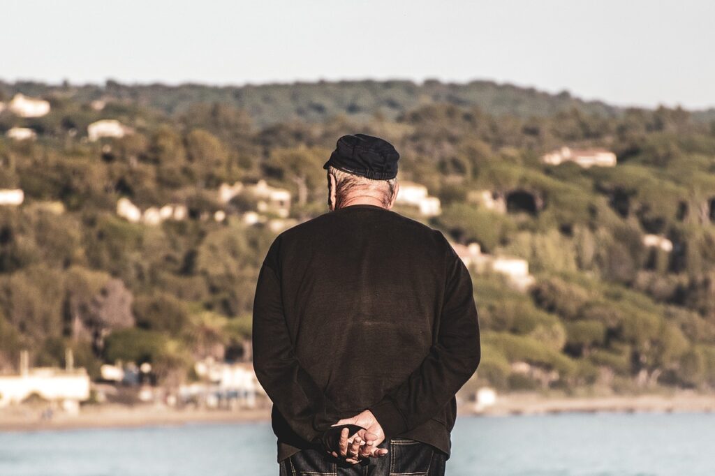 Senior citizen looking out over the water; contemplating future of Social Security