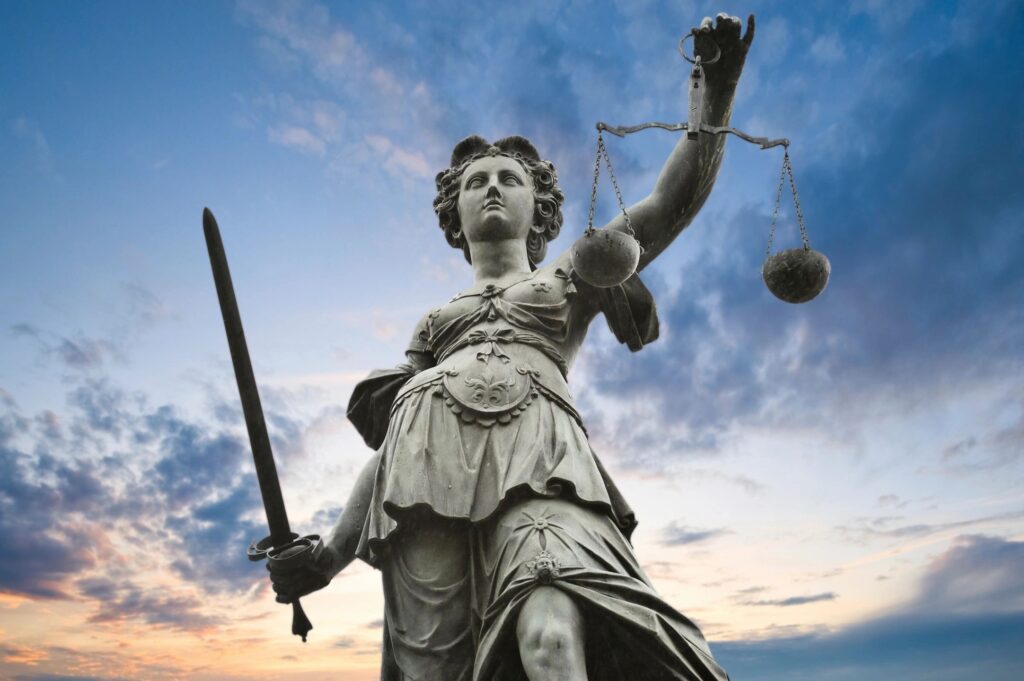 Statue of Lady Justice holding sword and scale;