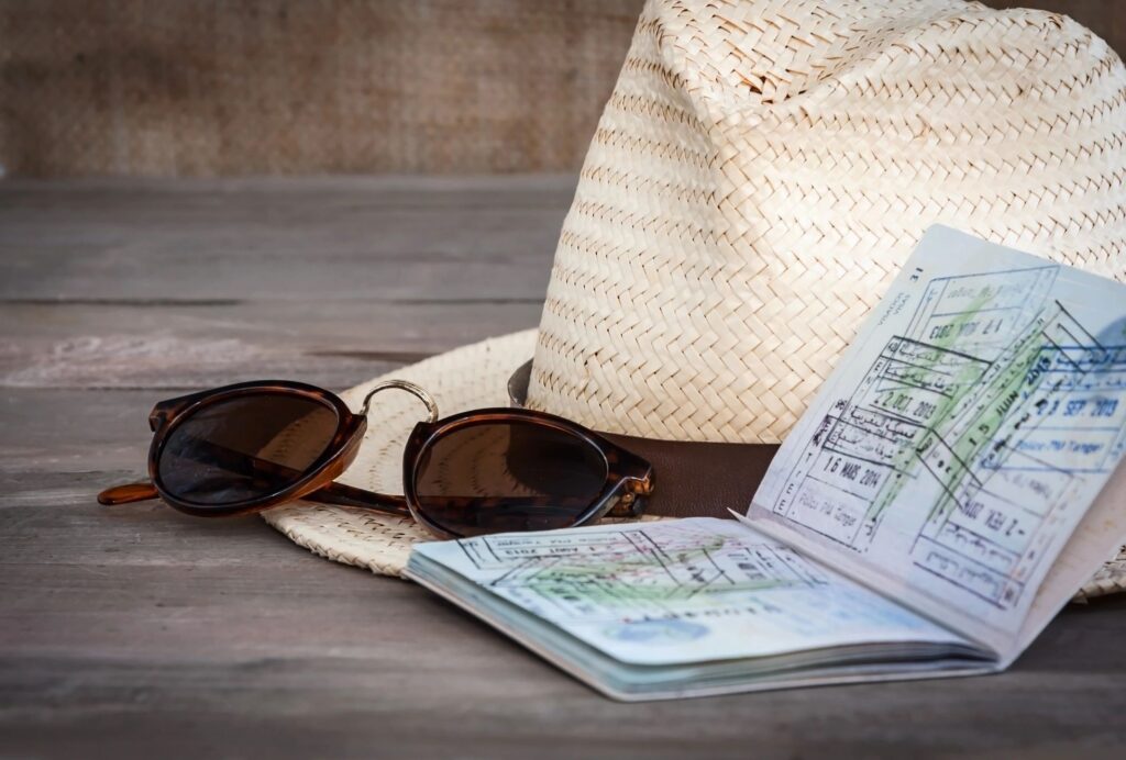 Passport, hat and sunglasses; vaccine cards for travel?