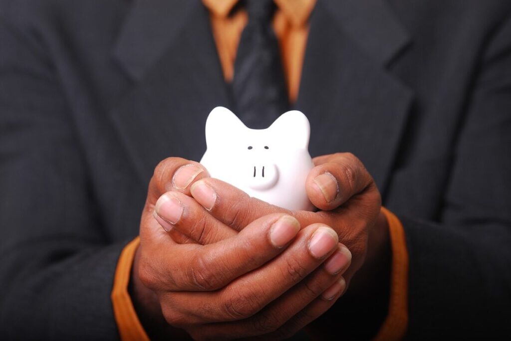 Payments; man holding piggy bank