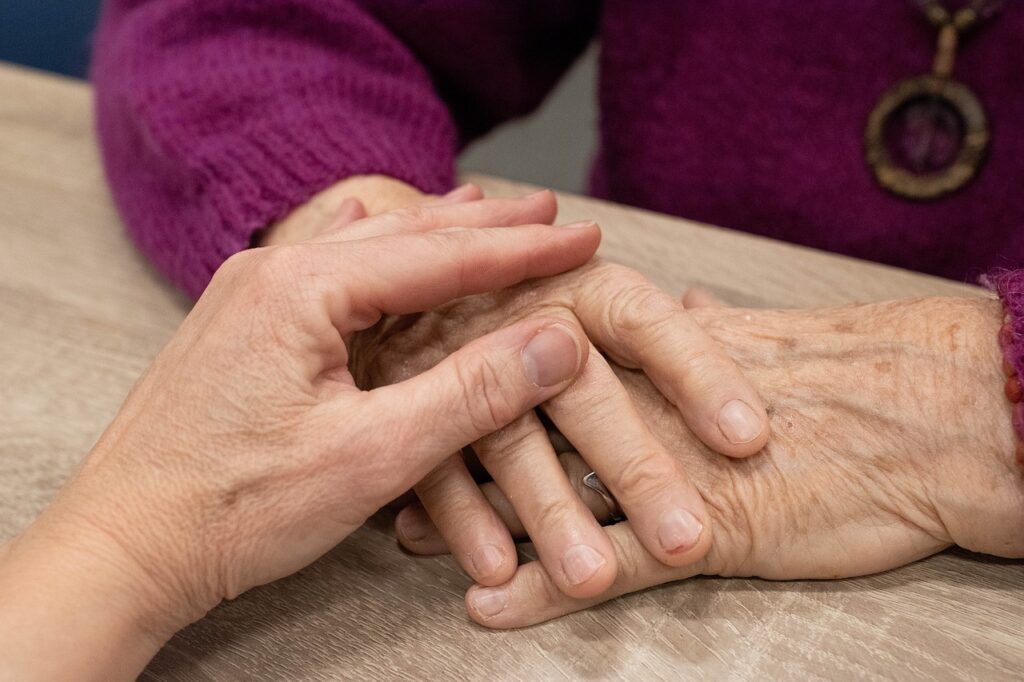 hand, consoling senior, survivor benefits