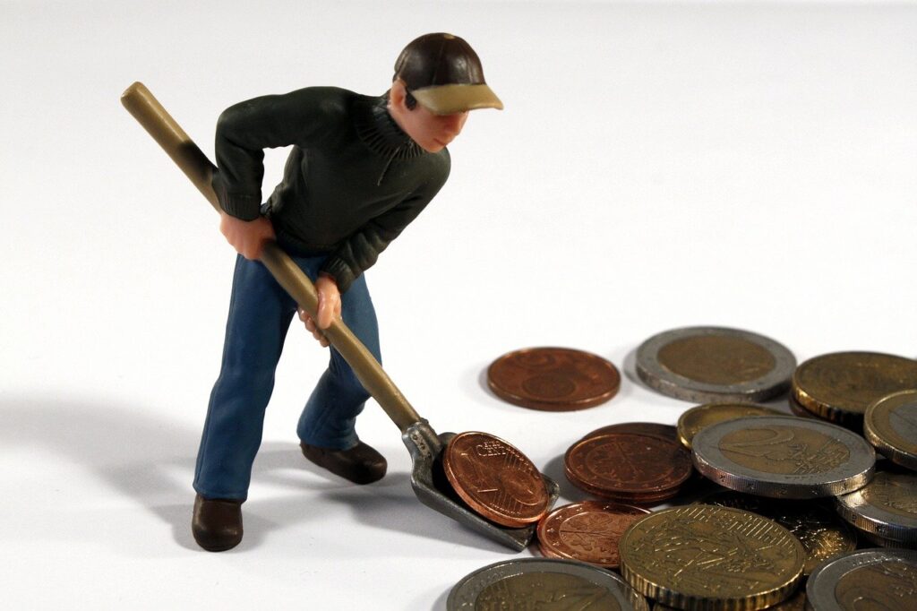 Man shoveling coins; benefit increase not enough for seniors