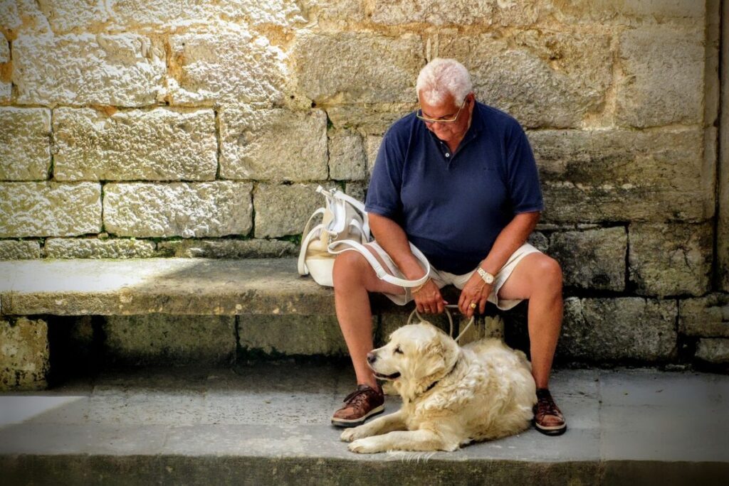 senior citizen resting with dog as Social Security's future looks bleak