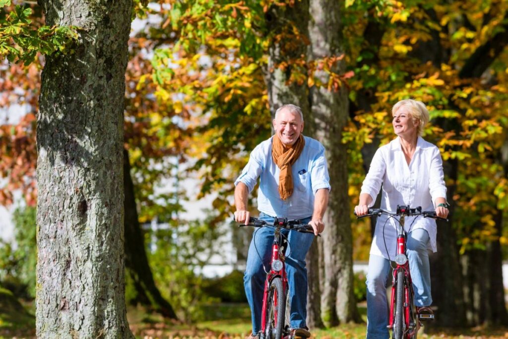 Retirees riding a bike; enjoying pay increase